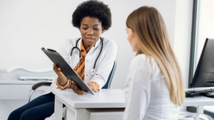 Healthcare professional reviewing documents with a client as part of a biologics CDMO evaluation process