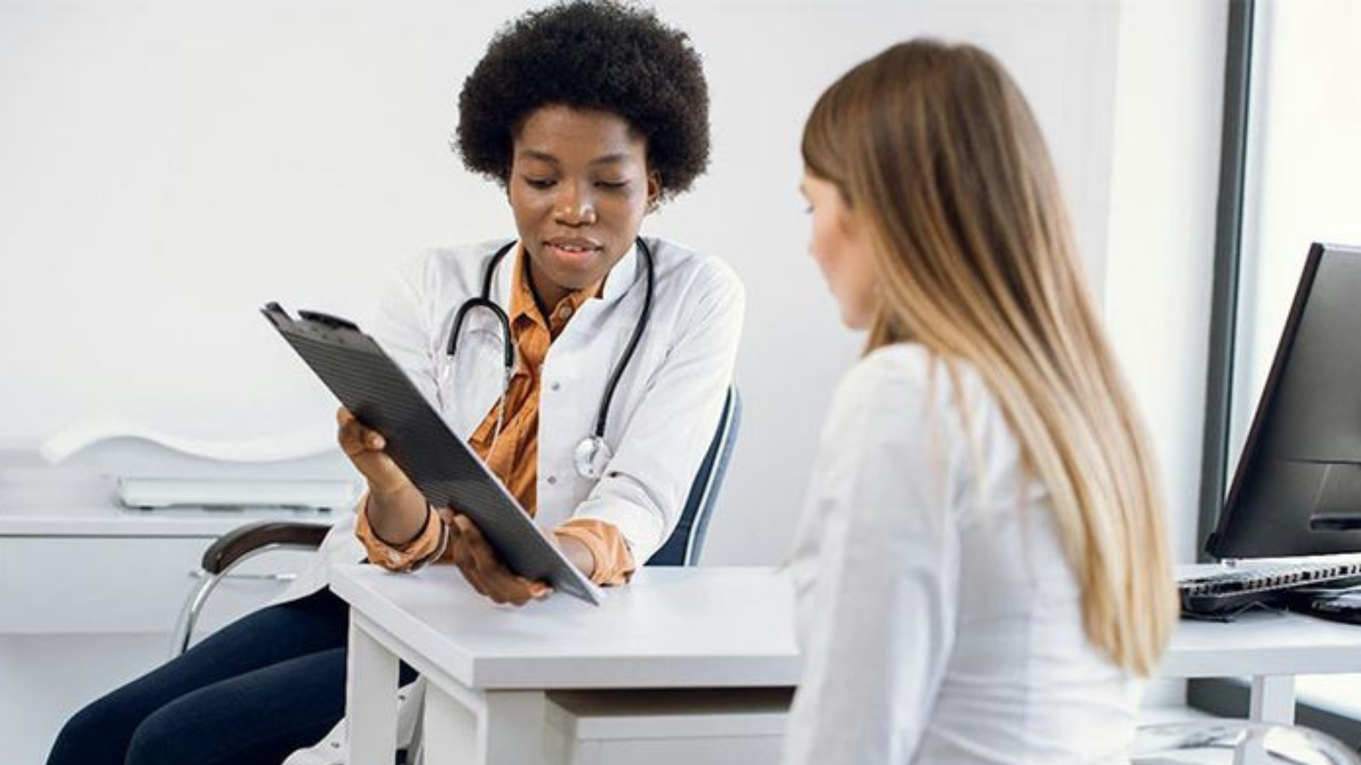 Healthcare professional reviewing documents with a client as part of a biologics CDMO evaluation process