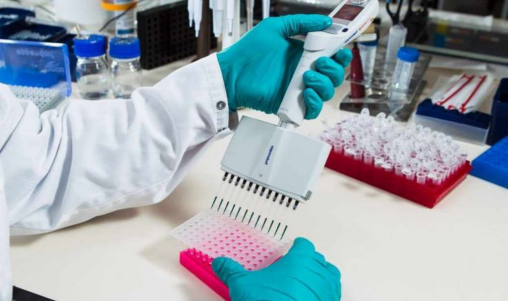 Biologics fill finish CDMO process showing laboratory technician handling samples during sterile fill-finish operations.